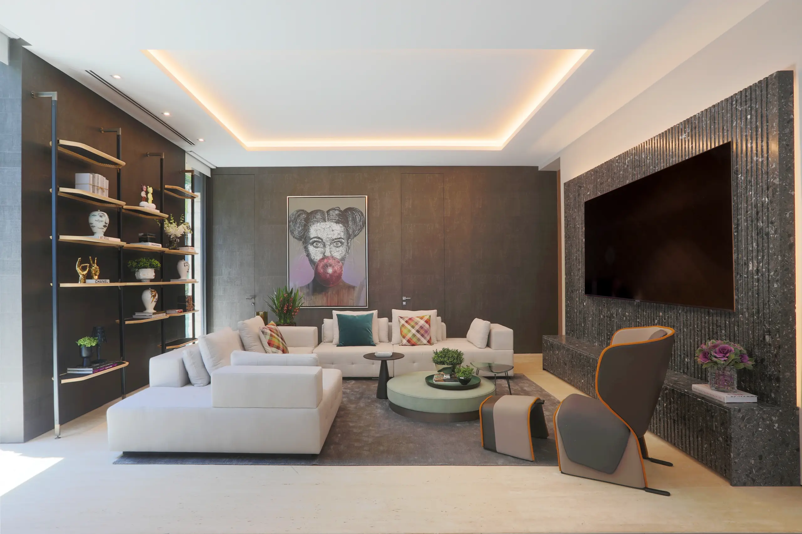 Contemporary living room with custom built-ins, sculptural armchair, and bold artwork in a Venetian Island luxury home
