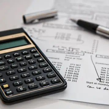 Calculator and financial documents for interior design project budget planning