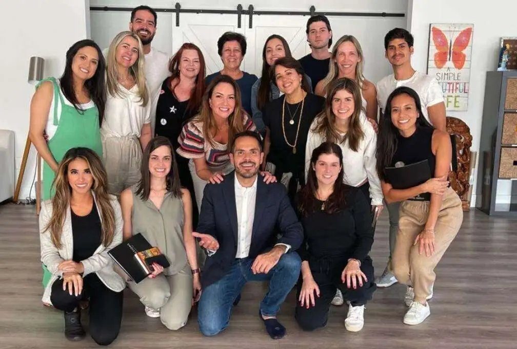 Interior design studio team posing together for a group photo in a bright office space
