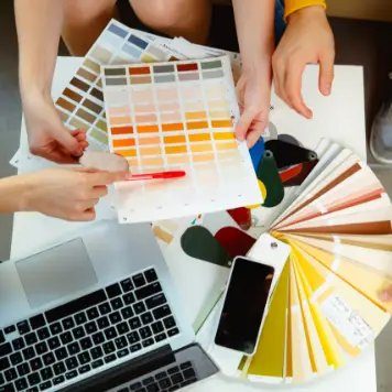 Interior design team reviewing color swatches and material samples