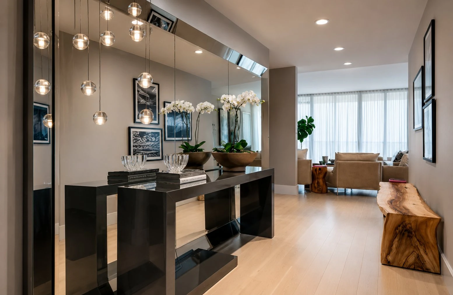 Modern entryway with black console table and glass globe pendant lights