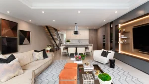 Open-plan living room and kitchen in a modern townhouse with floating staircase