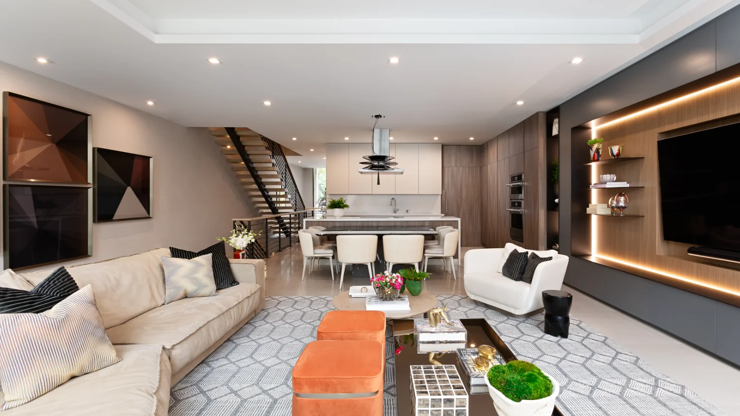Open-plan living room and kitchen in a modern townhouse with floating staircase